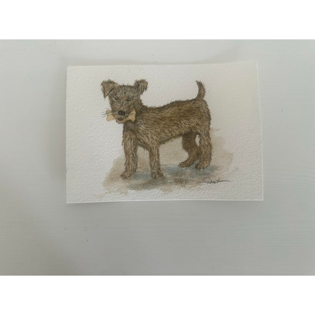A beautifully detailed terrier holding a beloved bone, painted with expressive brushwork and warm earth tones. The texture...