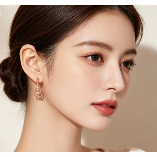 Material: 14K Rose Gold - elegant and durable Stones: Brilliant Round Diamonds - 0.2 carats per earring Style: Swirl Drop...