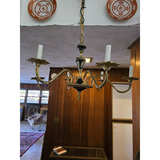 A vintage mid century original Hollywood Regency gilt bronze chandelier. Having sensuous branches spaced out beautifully...