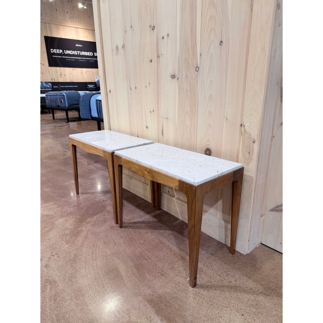 A handsome pair of vintage side tables from the Rhythm collection, presenting the warm character and restrained...