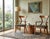 A handsome pair of vintage Empire Revival armchairs crafted in solid wood with a warm medium-brown finish and elegant...