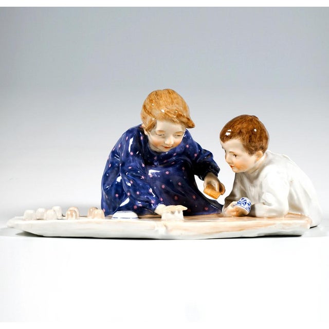 A very special group of children from the time the design was created: girl in a long-sleeved dress of blue-violet fabric...