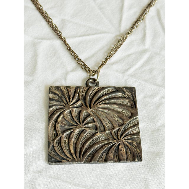 Vintage 1960s Coro pendant necklace featuring an oversized square philodendron leaf relief pendant with deeply textured...