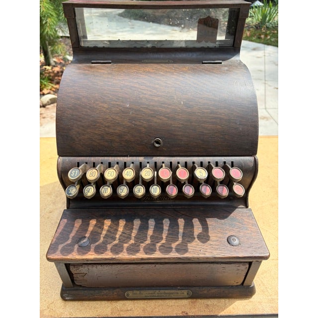 This antique National Cash Register in excellent working condition with wood-grain finish made in 1922 (Model 722 Serial #...