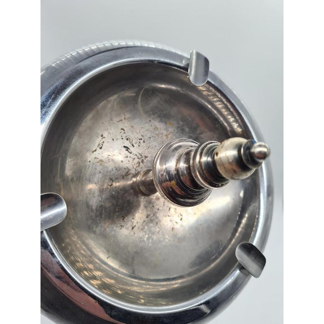 An elegant freestanding ashtray made of metal with a nickel-plated finish, designed in the Art Deco and early Modernist...
