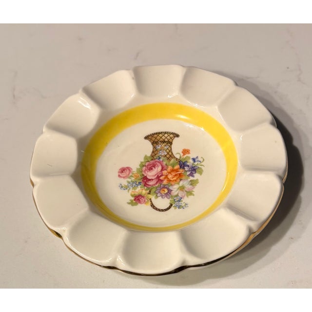 This tiny catchall makes a big visual impact thanks to the vibrant colors in the basket of flowers on it's face and the...