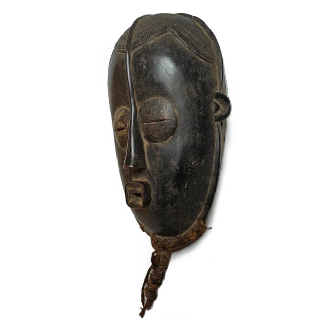 Old Bete hand carved wood tribal mask from West Africa region. Stylized traditional carved features and plaited rope hair...