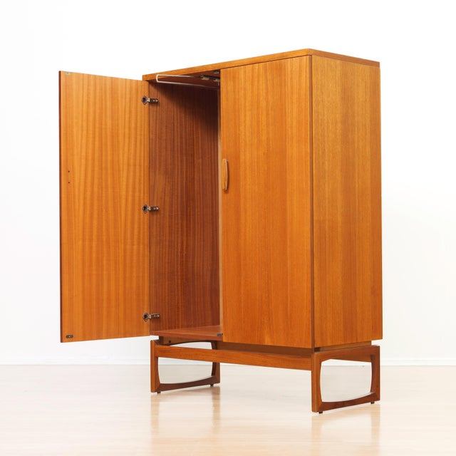 This mid-century armoire was produced by G Plan as part of their 'Quadrille' range during the 1960s. A sleek, teak...