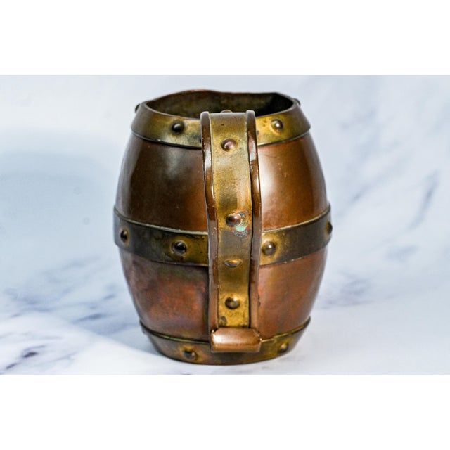 This antique copper mug, dating to circa 1915, is a striking example of Arts and Crafts design, fully handmade and...