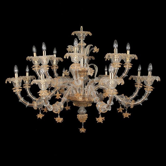 Murano glass chandelier, rezzonico style, blown and handcrafted with ancient technique. On each golden metal arm are...