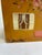 A whimsical hand-painted house-shaped box by folk artist Janet Lee, with a gabled roof decorated in roses and hearts and...
