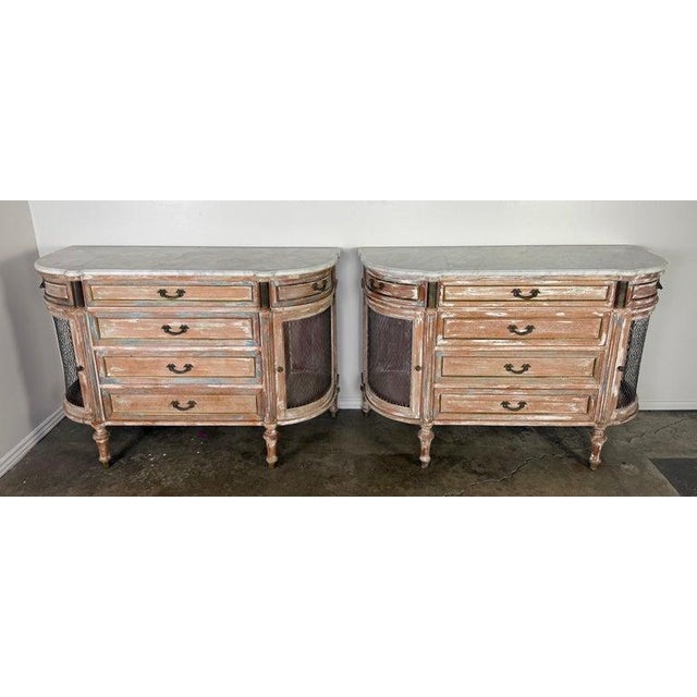 A refined pair of early 19th century Italian cabinets in the neoclassical taste, retaining their original painted finish...