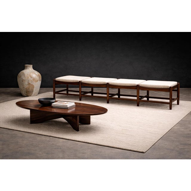 A striking Brazilian modernist modular bench crafted in richly figured rosewood with newly restored hand-woven cane seats,...