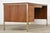 A mid century modern walnut desk made by Alma Furniture with light brass accents. Finished back. Professionally...