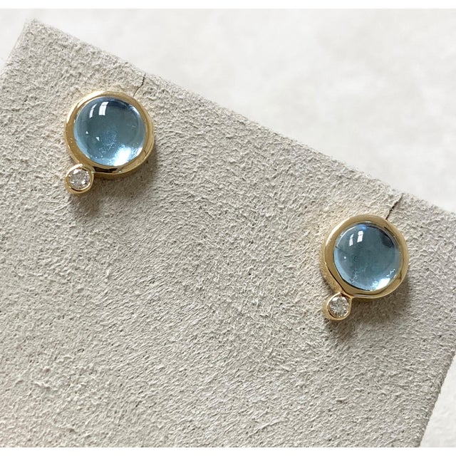 Created in 18 karat yellow gold Blue topaz 4 cts approx Diamonds 0.10 ct approx Can be worn at different angles Limited...