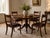 An antique Regency set of four mahogany dining chairs with beautifully figured bar backs, upholstered seats and elegant...