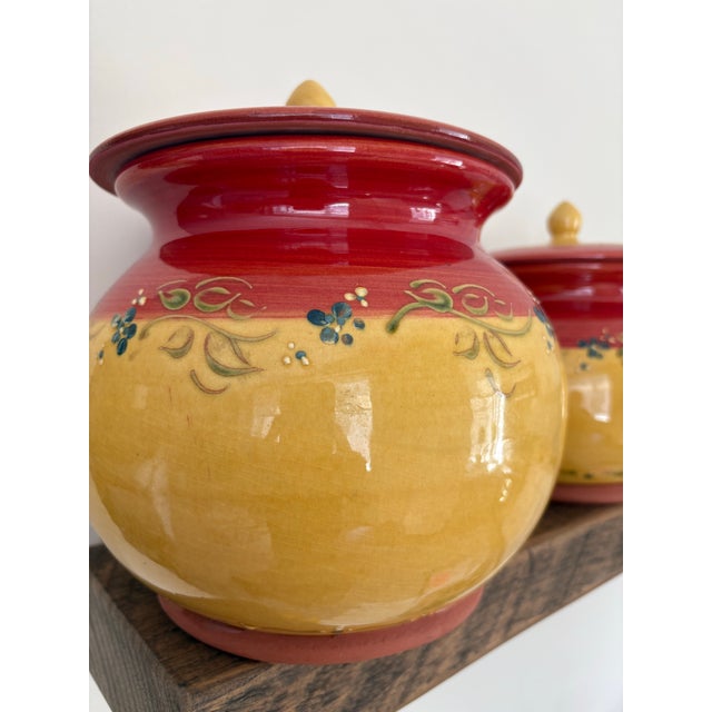 A charming set of three hand decorated French ceramic lidded canisters traditionally used to store dry pantry goods such...