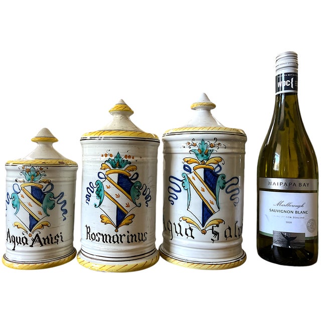 A charming set of three vintage Italian majolica apothecary jars, hand-painted in classic Old World style and labeled Aqua...