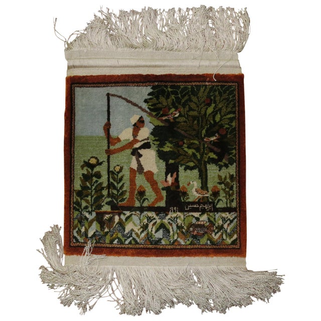 Silk Persian rug with a man holding a stick with 2 birds hanging on. A Duck is right behind. Signed by weaver, dated 1991....