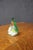 Handcrafted art glass paperweight in the form of a pear with an applied green leaf and stem. The clear glass body encloses...