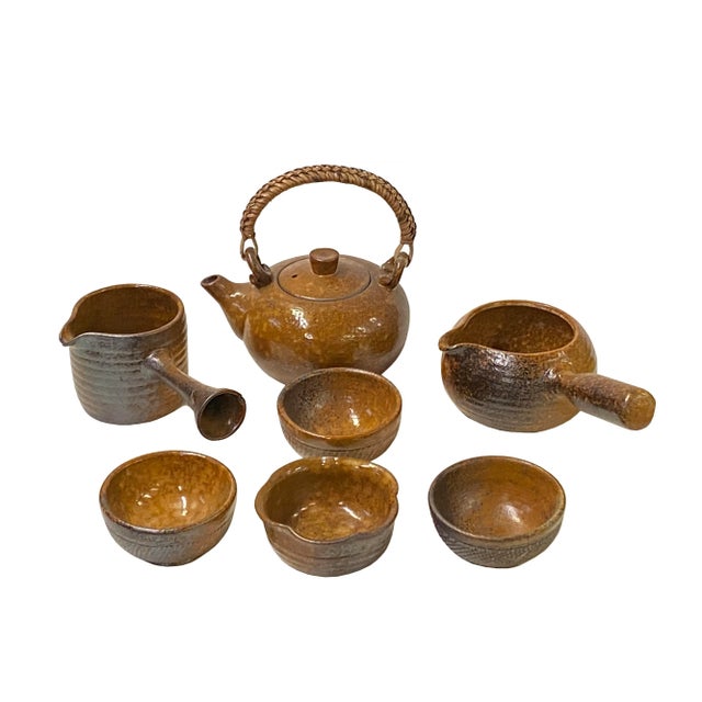 Elevate your space with this beautiful set of 7 ceramic pieces, including a teapot, teacups, and a decorative display, all...