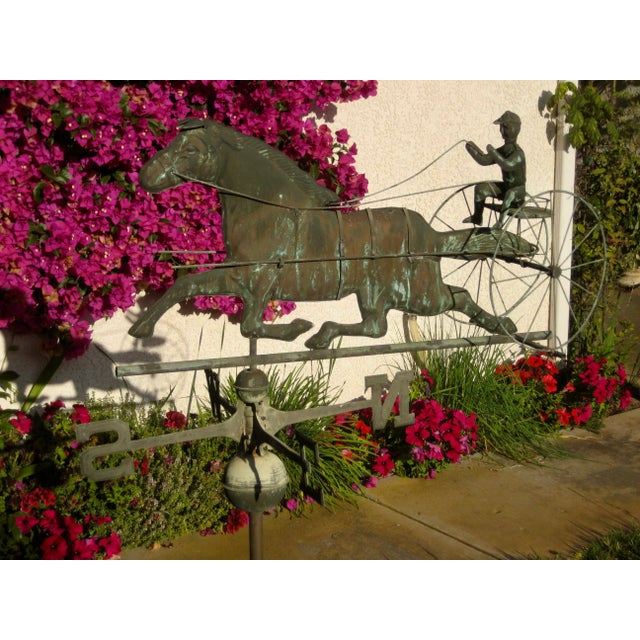 Lovely and complete model ,( pole , N,S,N,W, sign horse and jockey subject) of weathervane , horse and buggy and jockey...