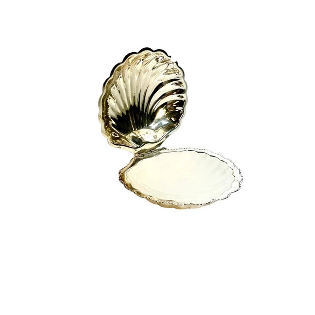 An elegant vintage English silver plate serving dish in a classic shell form, complete with its original fitted glass...