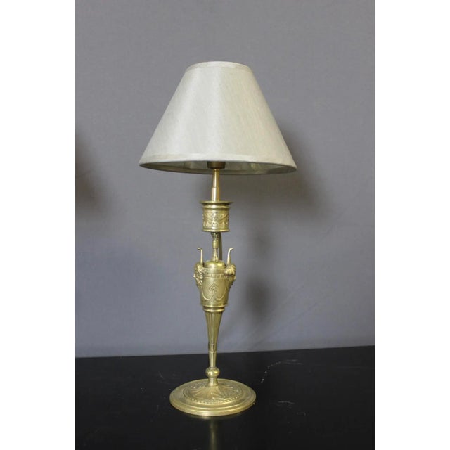 Pair of bronze lamps based on Napoleon III candlesticks decorated with men's and women's heads, new electrification, hat...