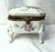 Lovely porcelain dresser box by Kalk. Set on feet, hand-painted with roses, and with ormolu fixtures
