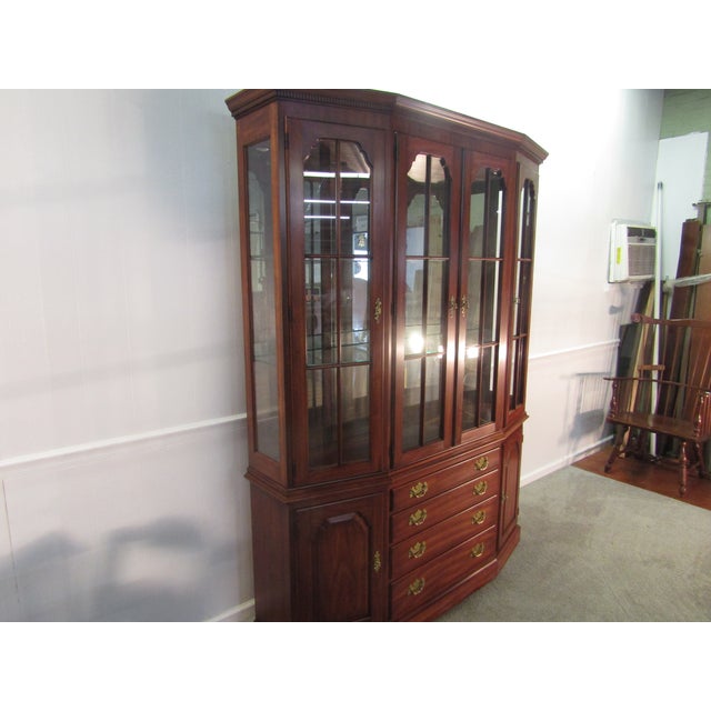 Item 87556: Henkel Harris solid cherry china cabinet. Age: 1993. Details: Two piece construction, lighted interior,...
