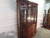 Item 87556: Henkel Harris solid cherry china cabinet. Age: 1993. Details: Two piece construction, lighted interior,...