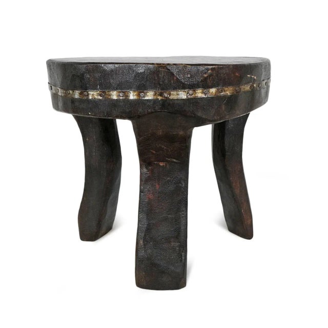 Original old Nagaland wood stool. Carved from a single piece of indigenous hardwood each with unique decorative iron trim...
