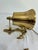 A vintage solid brass bell set on a cast anchor bracket with rope detailing, with a braided cotton pull rope. The bracket...