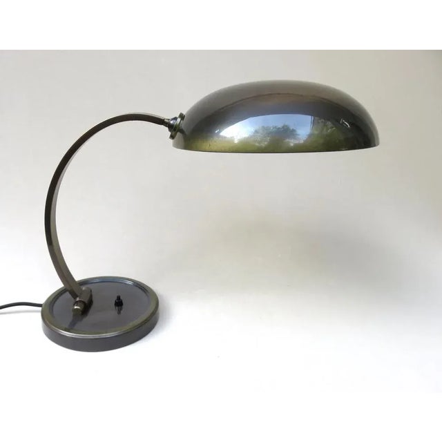 A desk lamp from the 30s of the Cosack brothers - Gecos made of patinated brass. The lamp has a socket E27. The lamp arm...