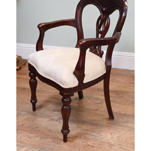 Attractive pair of Victorian mahogany armchairs, circa 1880. Each chair features a rounded balloon back with a decorative...
