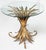 A fine Italian wheat sheaf cocktail or coffee table (or low table) from the Hollywood Regency era, featuring a round glass...