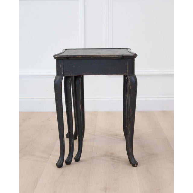 A charming set of Swedish Queen Anne style nesting tables featuring elegant cabriole legs and hand-painted black finishes....