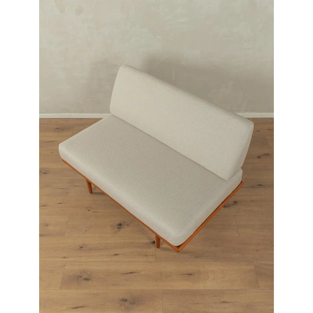 Charming sofa from the 1950s. High-quality frame with beechwood legs. The original spring core has been reupholstered and...