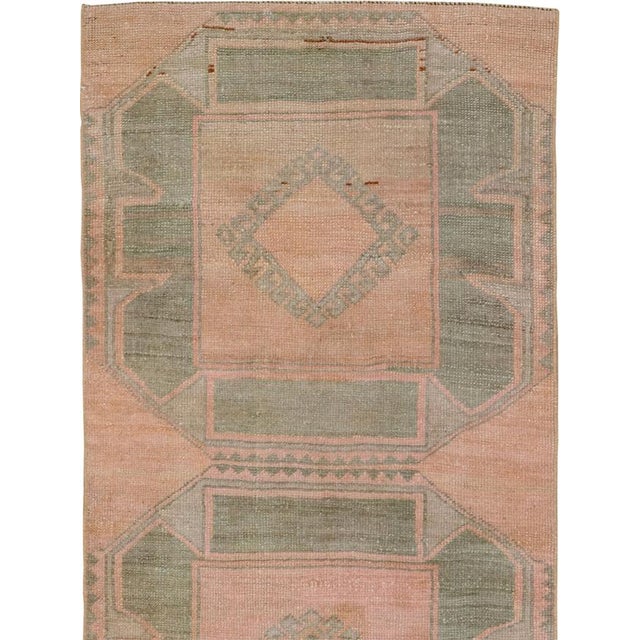 This mid-20th-century Turkish Anatolian runner features five large, vertically aligned octagonal medallions set against a...