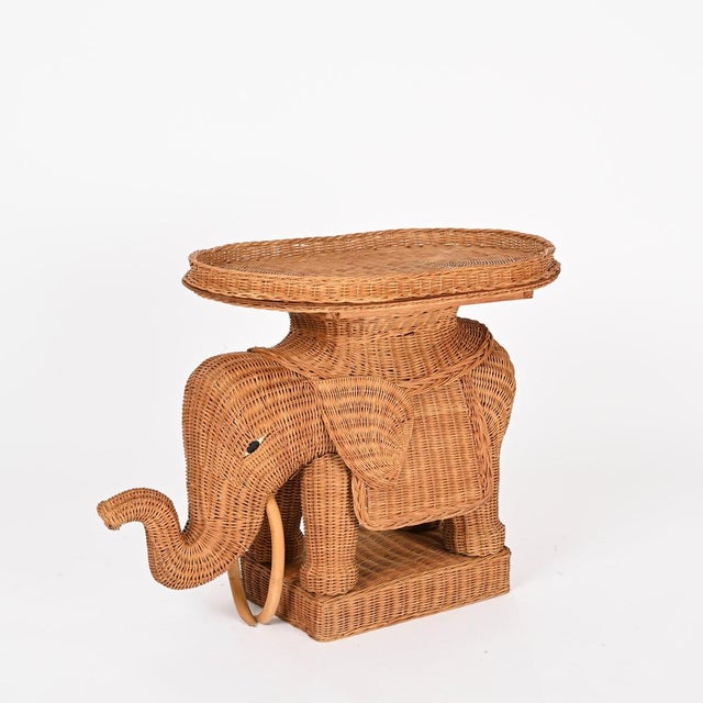 Marvelous midcentury elephant-shaped side table with removable tray fully made in hand-woven wicker. This gorgeous piece...