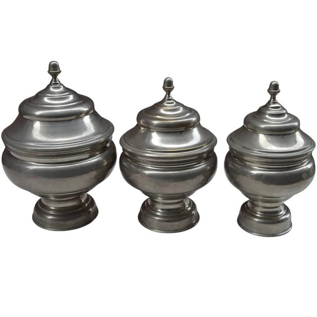 Set of three vintage handcrafted Moroccan lidded jars constructed of solid silver nickel. Ornate sleek smooth design and...
