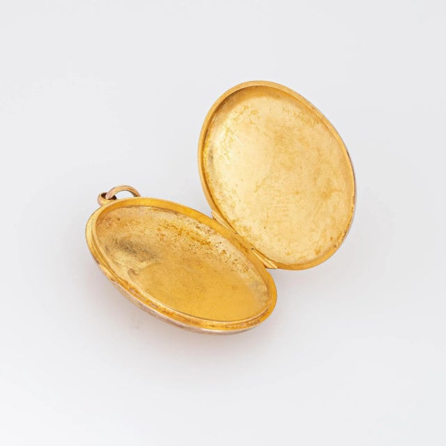 Elegant and finely detailed vintage Art Deco era locket (circa 1918) crafted in 9k yellow gold. The oval shaped locket...