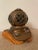 Vintage brass/copper scuba diving helmet sculpture from the 1960s. This is set on a wooden stand.