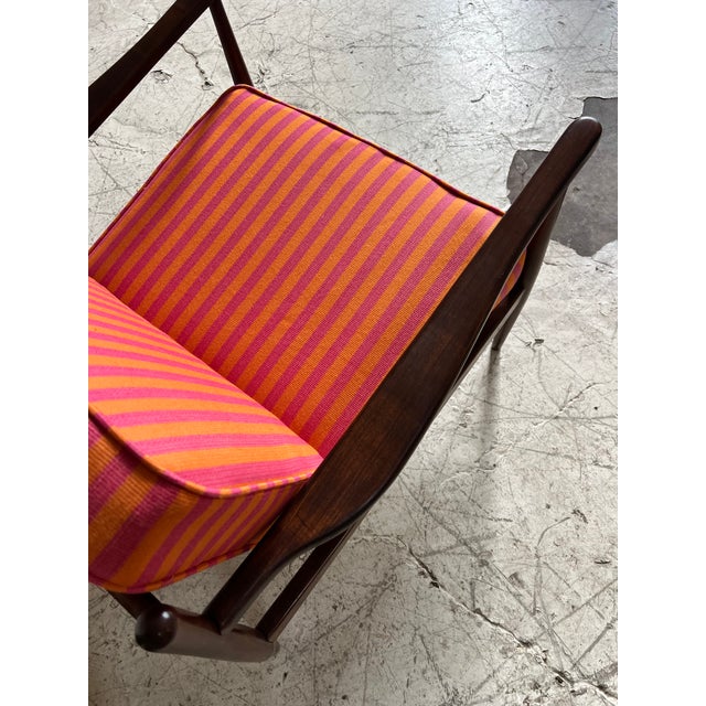 Newly refinished sculpted walnut lounge chair with spindle back frame, circa 1960's. Gorgeously reupholstered in a bright...