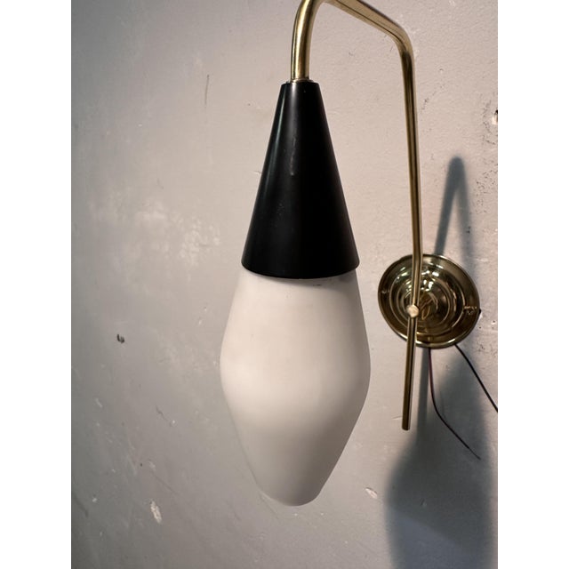 1950s wall light in brass and satin opaline glass European Plug (up to 250V).The wiring of this item may be original and...