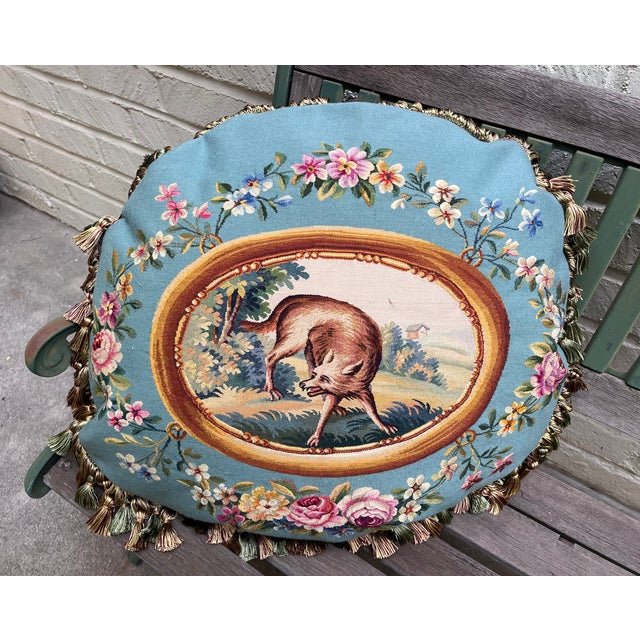 This great decorative pillow is upholstered in a finely woven wool and silk tapestry depicting a scene inspired by Les...
