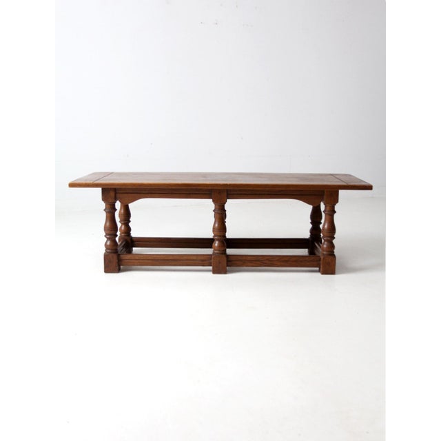 This substantial mid-20th century oak coffee table showcases a rustic, lodge-inspired design. Crafted from solid oak, it...