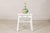 This vintage Chinese wooden stool features a simple country form elevated by a beautifully weathered white-painted finish....