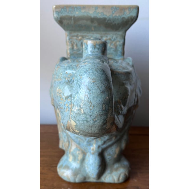 This charming Turquoise glazed ceramic plant stand is in the form of an elephant with the trunk up for good luck! Great to...