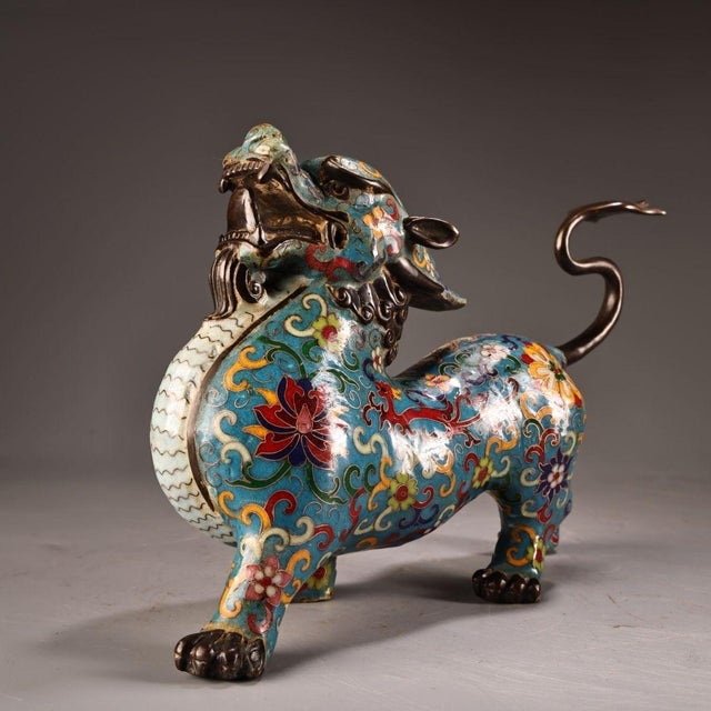 This striking sculpture depicts a mythical beast, likely a Pixiu or winged lion, a traditional symbol of wealth and...